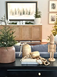 a living room decorated for christmas with ornaments and decorations on the coffee table in front of it