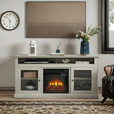 a living room with a fireplace and a large screen tv on the wall above it