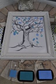 a tree with blue leaves painted on it next to some paint samples and a vase