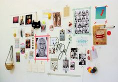 a white wall covered in pictures and magnets