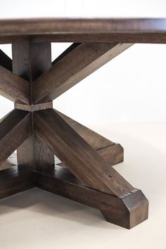 a wooden table that has been made out of wood and is sitting on a white surface