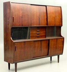 an old fashioned wooden cabinet with drawers on it's sides and two doors open