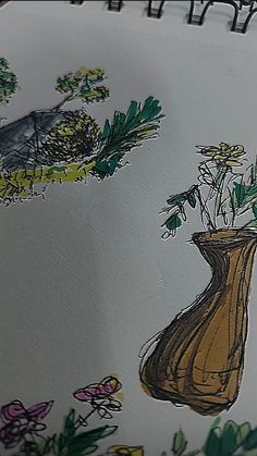 a drawing of a vase with flowers in it on top of a table next to an open notebook