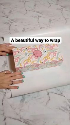 someone is wrapping up a paper with flowers on it and the words, a beautiful way to wrap