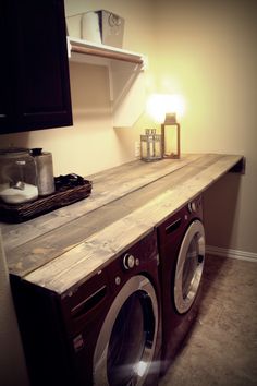 a washer and dryer sitting on top of a counter in a laundry room