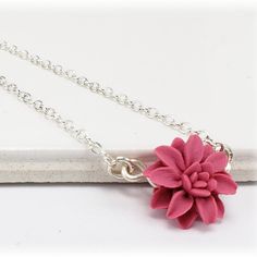 A minimalist style is featured with this petite hand sculpted Dahlia necklace for an everyday simple flower necklace or formal occasion including weddings. Choose your chain length as a choker necklace or longer. The tiny dahlia necklace flower measures approximately 12mm and is available in many colors and a choice of silver-plated, gold-plated, antique brass, 925 sterling silver or 14k gold filled components. Perfect for any occasion, formal or everyday wear.  -Flower size : approximately 12mm -Components : Choose silver-plated, gold-plated, antique brass, 925 sterling silver or gold filled -Length : Choose 16 or 18 inch cable chain -Color : Pictured Mauve. More colors available. View matching collection at:  https://www.etsy.com/shop/strandedtreasures/search?search_query=dahlia This ite Delicate Adjustable Necklace With Flower Charm, Dainty Flower Pendant Necklace - Gift For Her, Delicate Flower Pendant Necklace, Delicate Necklace With Flower Charm, Delicate Flower Pendant Necklace Adjustable, Delicate Adjustable Necklace With Flower Pendant, Delicate Adjustable Flower Necklace With Delicate Chain, Adjustable Flower Necklace With Delicate Chain, Adjustable Delicate Flower Necklace With Delicate Chain