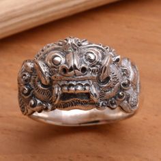 Barong centers this fascinating ring by Nyoman Rena. Also known as Bhoma he represents the goodness that destroyed the evil Rangda. His adventures are reenacted in the form of a dance and his image is also hung on doors in Bali to ward off evil spirits. .925 Sterling silver Adjustable Symbolic Carved Rings, Queen Of Witches, Unkempt Hair, Wild Eyes, Sterling Silver Rings Bands, Silver Work, Sterling Silver Mens, Silver Band Ring, Men's Ring