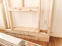 a wooden shelf sitting on top of a hard wood floor