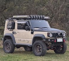 an off - road vehicle is parked in the grass