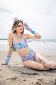 Ready to rave by the waves? This stunning rave girl showcases a playful floral bikini set, perfect for beachside festivals. Complete with matching arm sleeves and fluffy ear accessories, this outfit is all about fun and vibrant vibes. Ideal for dancing under the sun and enjoying the festival season. 🏖️🎶 #RaveOutfit #FestivalFashion #RaveGirl #MusicFestivalOutfit #FreedomRaveWear #BeachVibes #FloralFashion Rave Tops, Mushroom Pattern, Ear Accessories