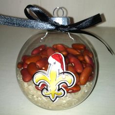 a glass ornament filled with peanuts and a fleur de lis decoration