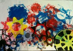 an art project with different colored shapes and colors on the paper, including black, red, blue, yellow and green