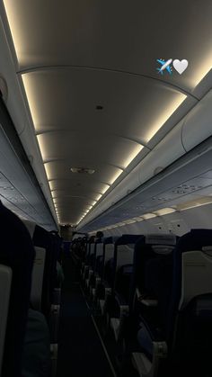 the inside of an airplane with blue and white lights on it's ceiling is empty