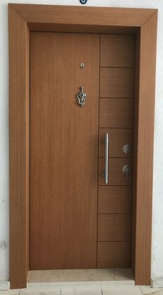 the door is made of wood and has metal handles