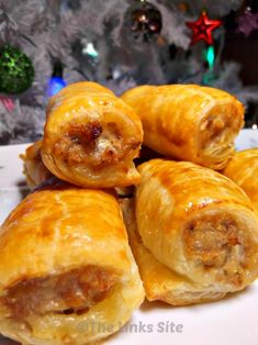 several pastries stacked on top of each other in front of a christmas tree