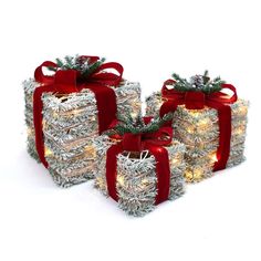 christmas presents wrapped in tinsel with red bows and lights