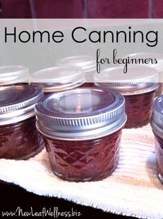 jars filled with jam sitting on top of a towel