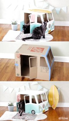 the cat is sitting in the cardboard house