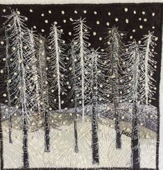 a quilted wall hanging with trees in the snow