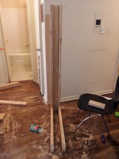 a room that is being remodeled with wood flooring and construction tools on the ground