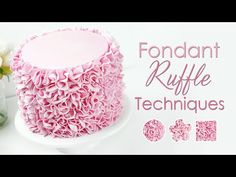 a pink ruffle cake sitting on top of a white plate next to some flowers