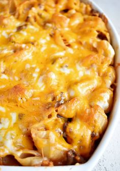 a casserole dish with cheese and meat in it