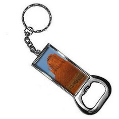 a metal key chain with an image of a building on it's back side