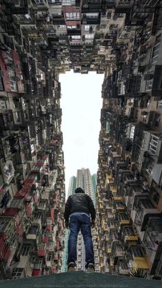 a man standing in the middle of a tall building