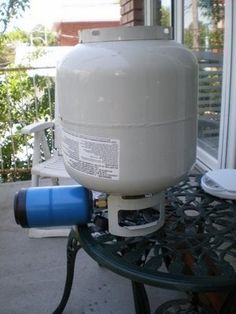 a large propane tank sitting on top of a patio table next to a window