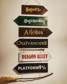 a sign hanging from the side of a wall that says harry potter, hogwarts, azkaban, ollivanders, diagon alley and platform