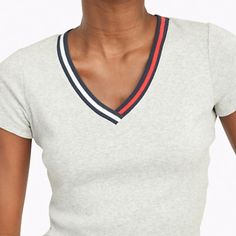 Size M Color: Grey Heather Tommy Hilfiger Women's T-Shirt. Made From Soft, Comfortable Cotton, Our Tee Features A V-Neck, Trimmed With Signature Colors. Regular Fit. 100% Cotton. Tommy Hilfiger Sporty T-shirt For Summer, Tommy Hilfiger Sporty Summer T-shirt, Tommy Hilfiger V-neck Tops, Fitted Tommy Hilfiger V-neck Tops, White Short Sleeve Tommy Hilfiger Top, Tommy Hilfiger White Short Sleeve Top, Tommy Hilfiger Fitted V-neck Tops, Fitted V-neck Tommy Hilfiger Tops, Tommy Hilfiger Sporty Summer Tops