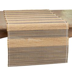 the table runner is made out of jute and has stripes in black, tan and white