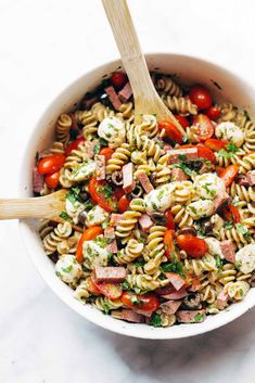 a bowl filled with pasta and vegetables on top of a table