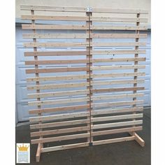 two wooden slats are stacked on top of each other in front of a garage door