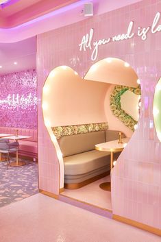 the inside of a restaurant with pink walls