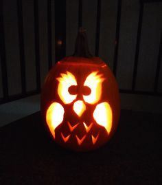 a carved pumpkin with an owl face on it