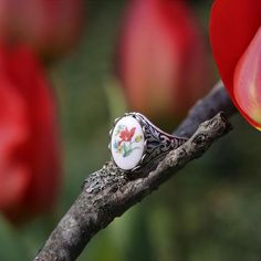 Victorian style German Tulip Cameo.  Available on an antiqued brass or silver vintage ring.I do not recommend that this be worn while bathing or swimming although normal handwashing is fine. Vintage Open Enamel Ring For Gift, Vintage Enamel Open Ring Gift, Vintage Silver Flower Ring For Jewelry Making, Vintage Silver Flower Ring Gift, Vintage Silver Flower Ring For Gift, Vintage Open Ring With Cabochon, Vintage White Oval Cabochon Ring, Silver Vintage Flower Ring For Gift, Vintage Silver Enamel Ring For Wedding