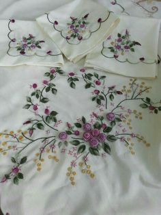 an embroidered bed spread with flowers on it