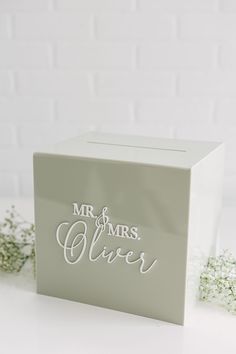 a white box with the words mr and mrs silver on it next to some baby's breath flowers