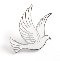 a white bird pin sitting on top of a table