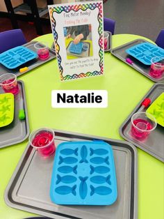 a table topped with plastic trays filled with food