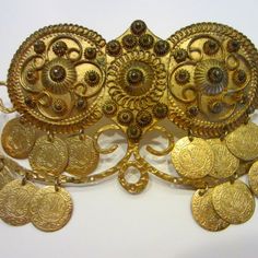 A Folk Art. Certainly A Timepiece, A Bold Glamorous, Gorgeous, Exciting, And Unique. A Large Gold Plated, Dress, Fur, And Or Hair Clip, A Pendant Or Brooch, Could Be A Buckle From Vintage Era. Decorated With Charms Of Golden Coins Likely From Middle Eastern Cities, All Scripted, Designed, Incised, Numbered And Chased. The Mark Incised On Center Indicates, Made In Greece. Overall In Great Aged Condition, Perhaps Missing Few Coins... 6" X 3". A One Of A Kind In My Neck Of The Wood. Plated Dress, Golden Coins, Dress Fur, Golden Coin, Rare Coins, Middle Eastern, Hair Clip, Time Piece, Folk Art