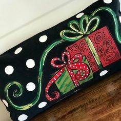 a black and white polka dot purse with a red present on it