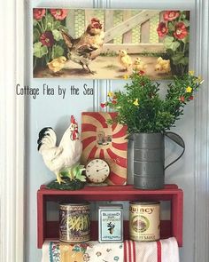 a red shelf with various items on it next to a painting and potted plant