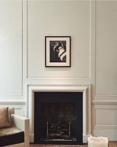 a living room filled with furniture and a fire place in front of a painting on the wall