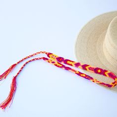 These Beautiful hat bands are carefully hand woven by Rosa in Chiapas,Mexico. Each band showcases a unique and colorful patterned design using traditional macrame techniques. Add a touch of handmade artistry to your hat collection today! Width 1” Length: 23 inches, not including fringe Fringe 9” each side , for an adjustable fit. Fits most hats Polyester yarn All items are shipped from US. All Mi Mundo Mexicano items are 100% handmade by artisans in Mexico. Each stitch and item is completely uni Adjustable Handwoven Straw Hat With Flat Brim, Adjustable Flat Brim Handwoven Panama Hat, Adjustable Handwoven Panama Hat With Flat Brim, Natural Toquilla Straw Hat Bands For Festivals, Adjustable Handwoven Flat Brim Panama Hat, Adjustable Braided Toquilla Straw Hat, Festival Toquilla Straw Hat Bands, Adjustable Multicolor Toquilla Straw Sun Hat, Handmade Southwestern Multicolor Hats