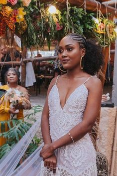 a woman in a wedding dress standing under a canopy