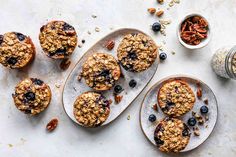 blueberry oatmeal breakfast muffins on plates next to a jar of granola