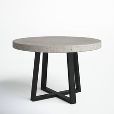 a concrete table with black metal legs on a white background