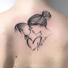 a woman's back with a drawing of a mother holding her baby in the shape of a heart